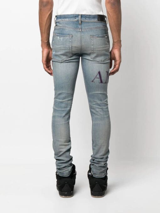 AMIRI  ripped-knee logo-print skinny jeans - Image 4